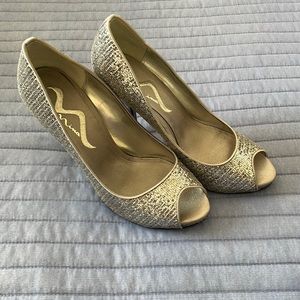 Brand new high heeled silver shoe